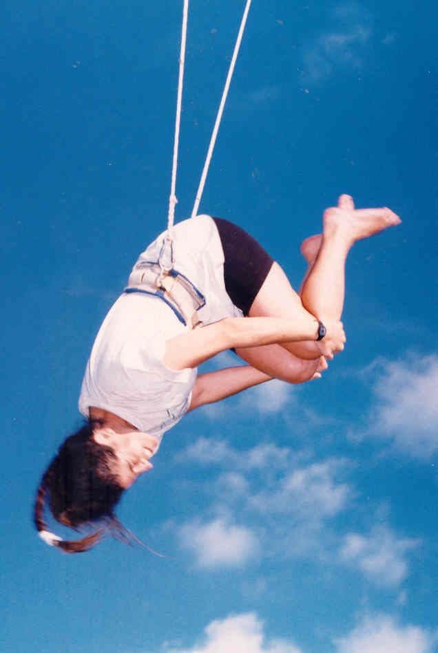 Dr. Edy Greenblatt performing a knee hang on the flying trapeze